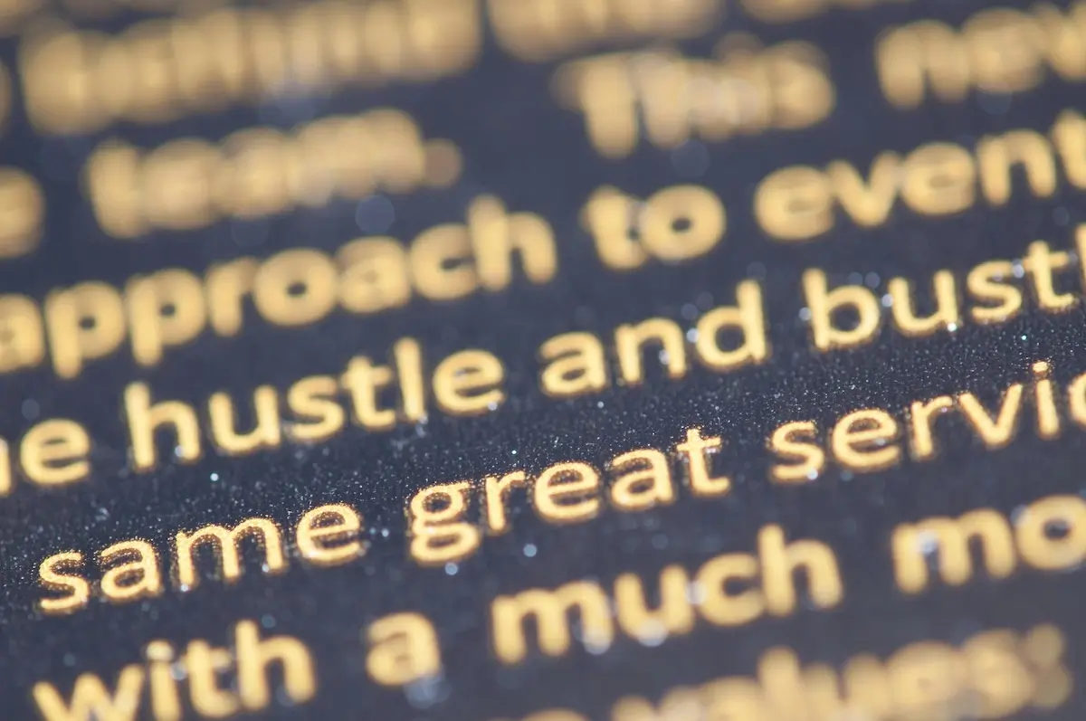Words in gold printed text on black paper