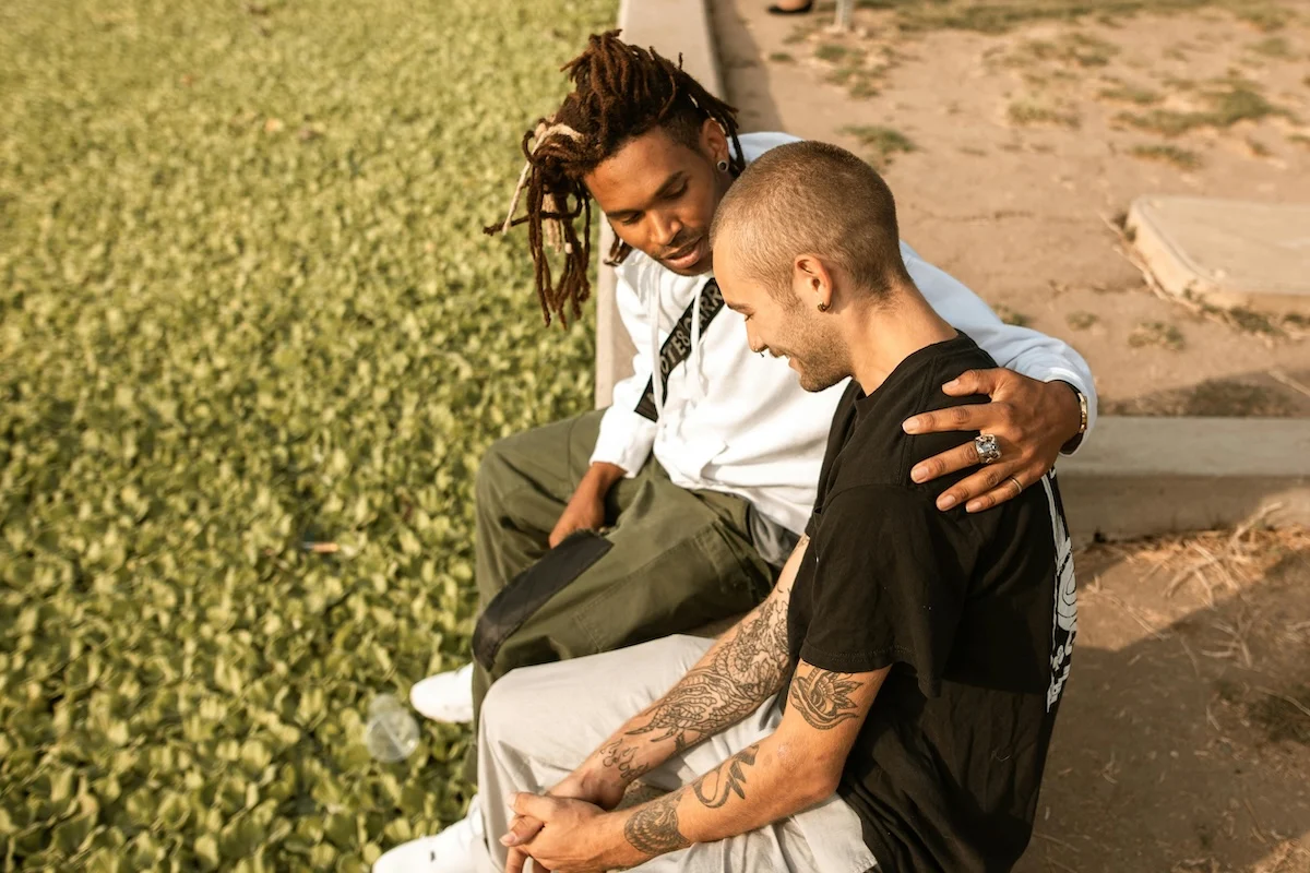 Man with his arm on the shoulder of another man