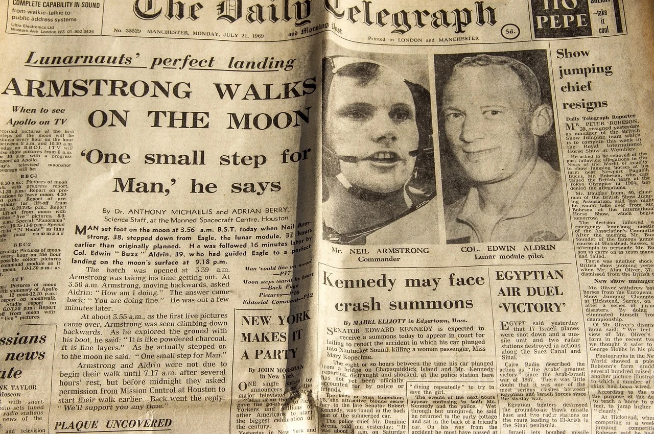 The Daily Telegraph newspaper with the headline 'Armstrong walks on the moon'.