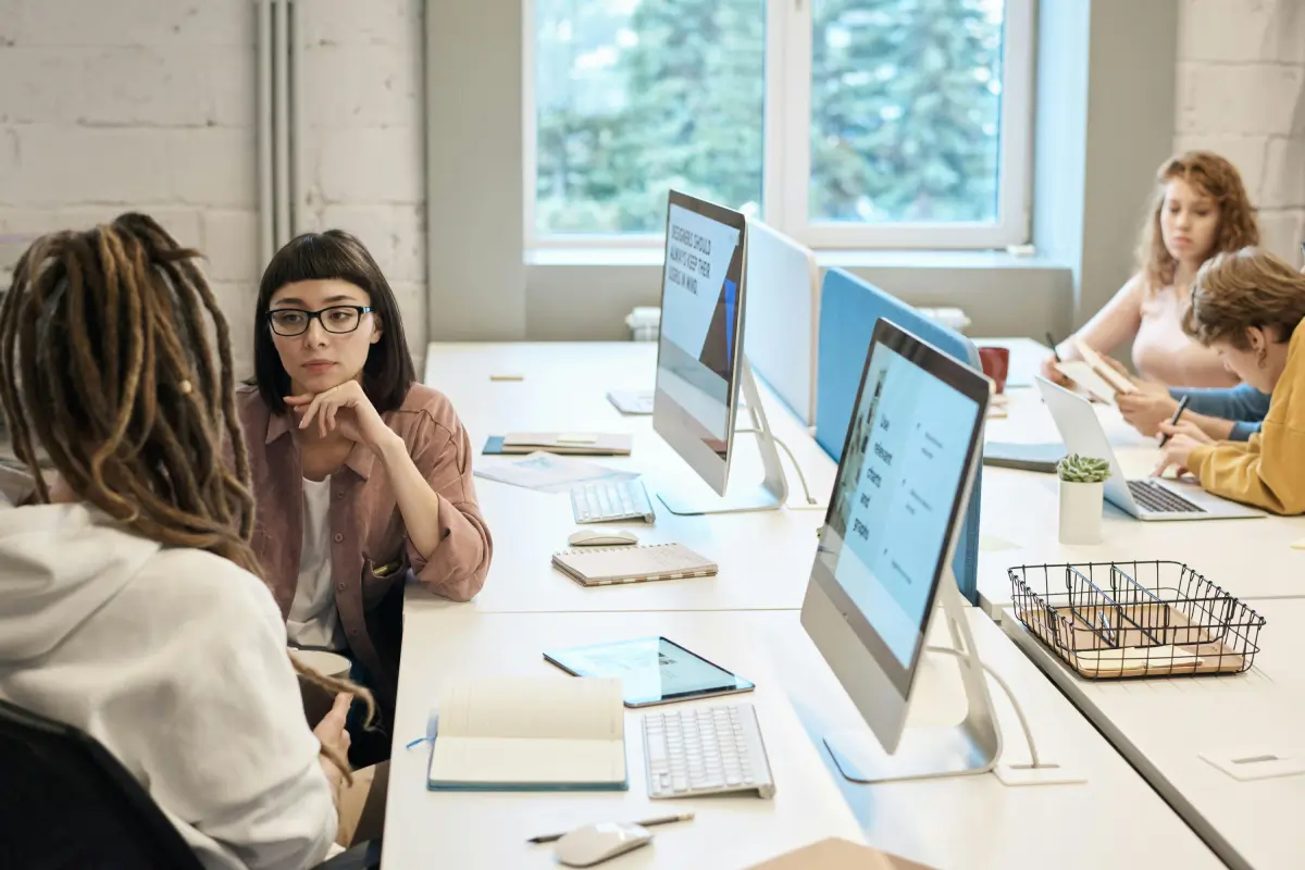 A group of people having a meeting about dApps