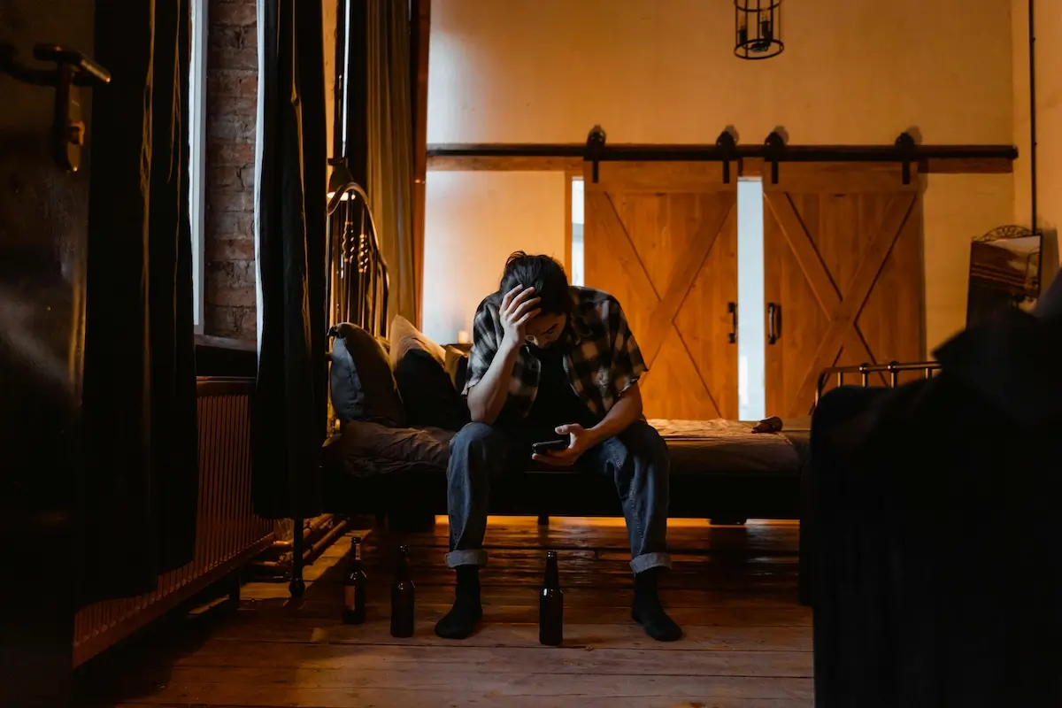A downbeat man looking at his smartphone by MART PRODUCTION on Pexels. com