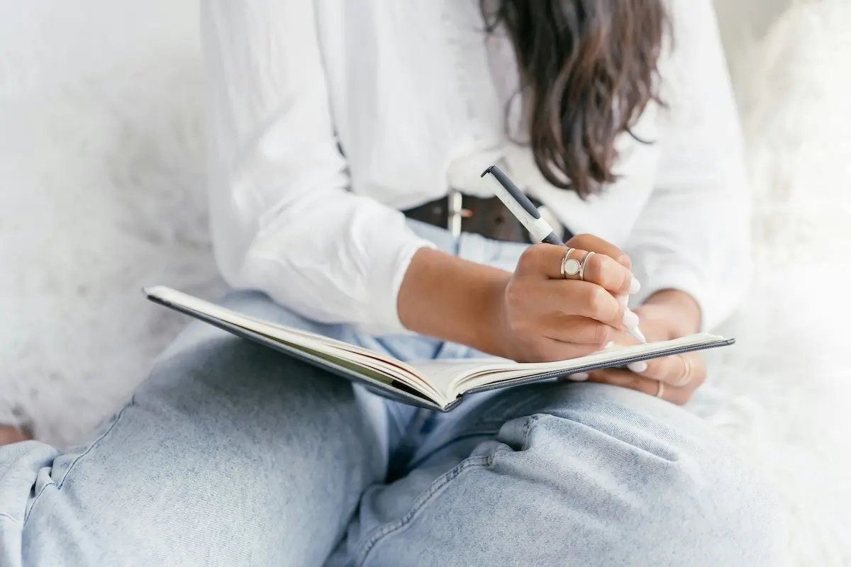 A woman writing in a notebook