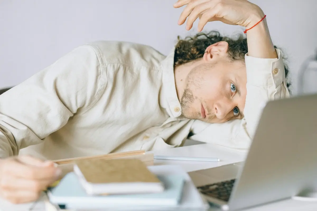 Man feeling imposter syndrome staring at his laptop