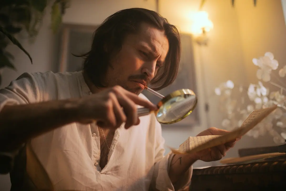 Man looking through a magnifying glass at GEO