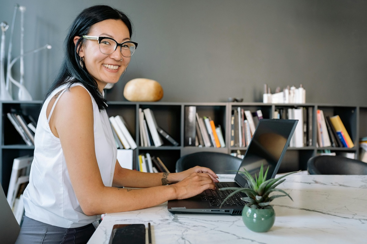 Happy woman on a web3 site on her laptop