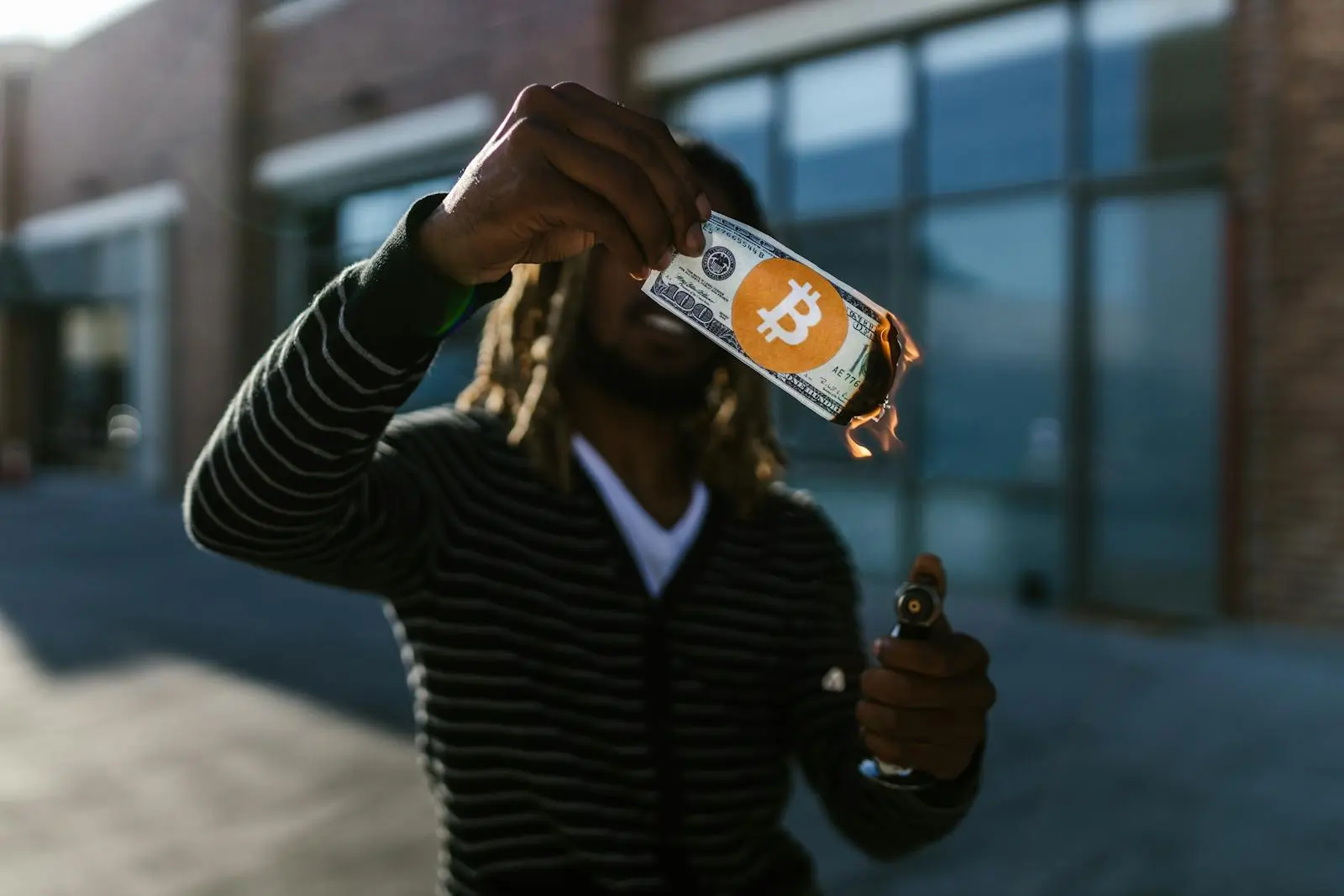 Man Burning a 100 Dollar Bill by RDNE Stock project on pexel.com