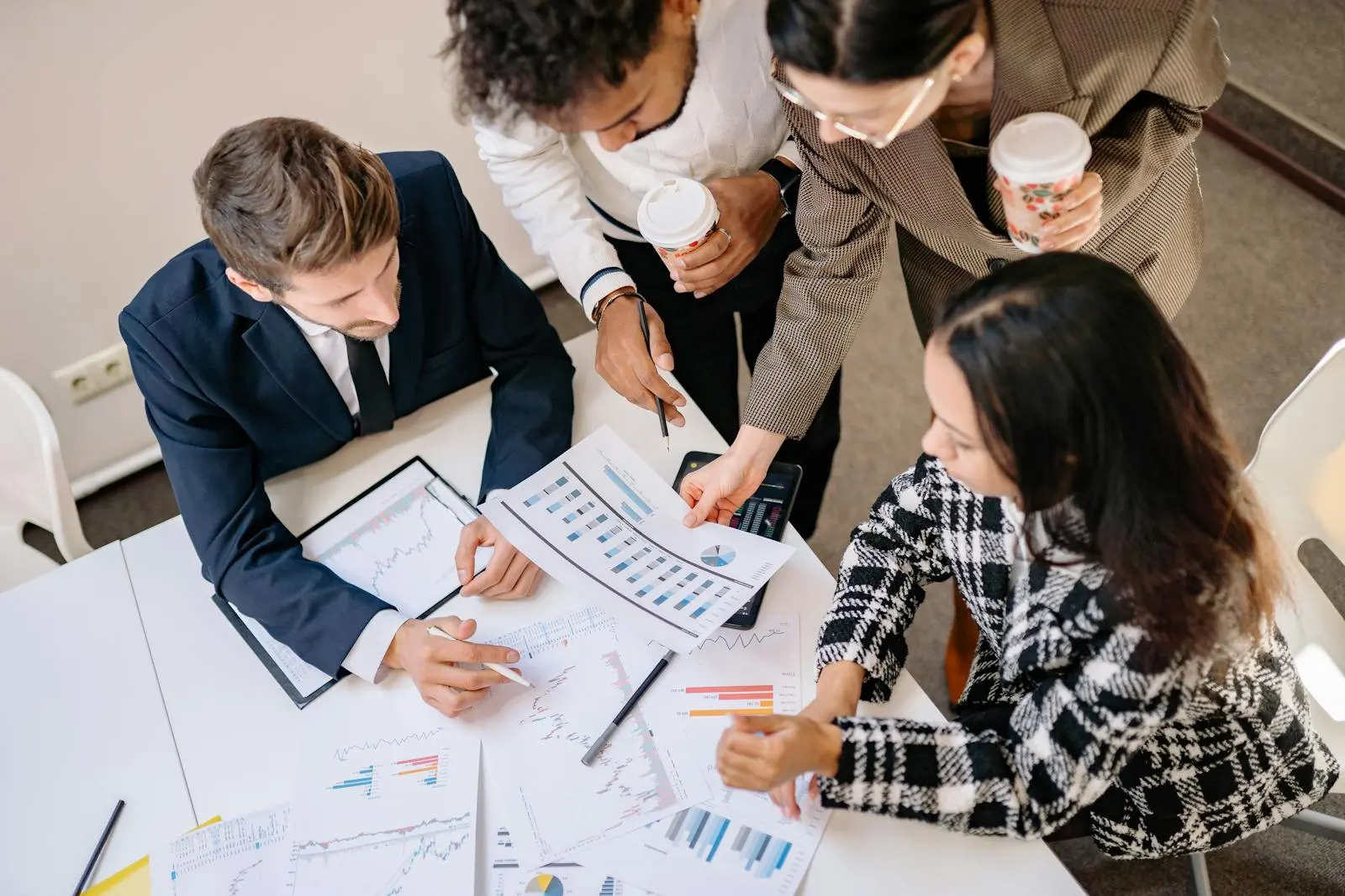 A Group of Business Partner Looking at a Graph Print Out by Yan on pexel.com