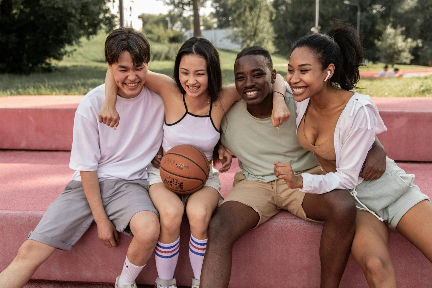 4 teenagers embracing sitting next to each other, signifying micro-communities by Monstera Production on Pexels. com