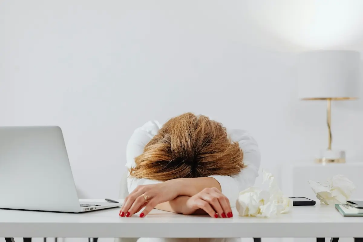 A tired woman overworking on AI by Karola G on Pexels. com