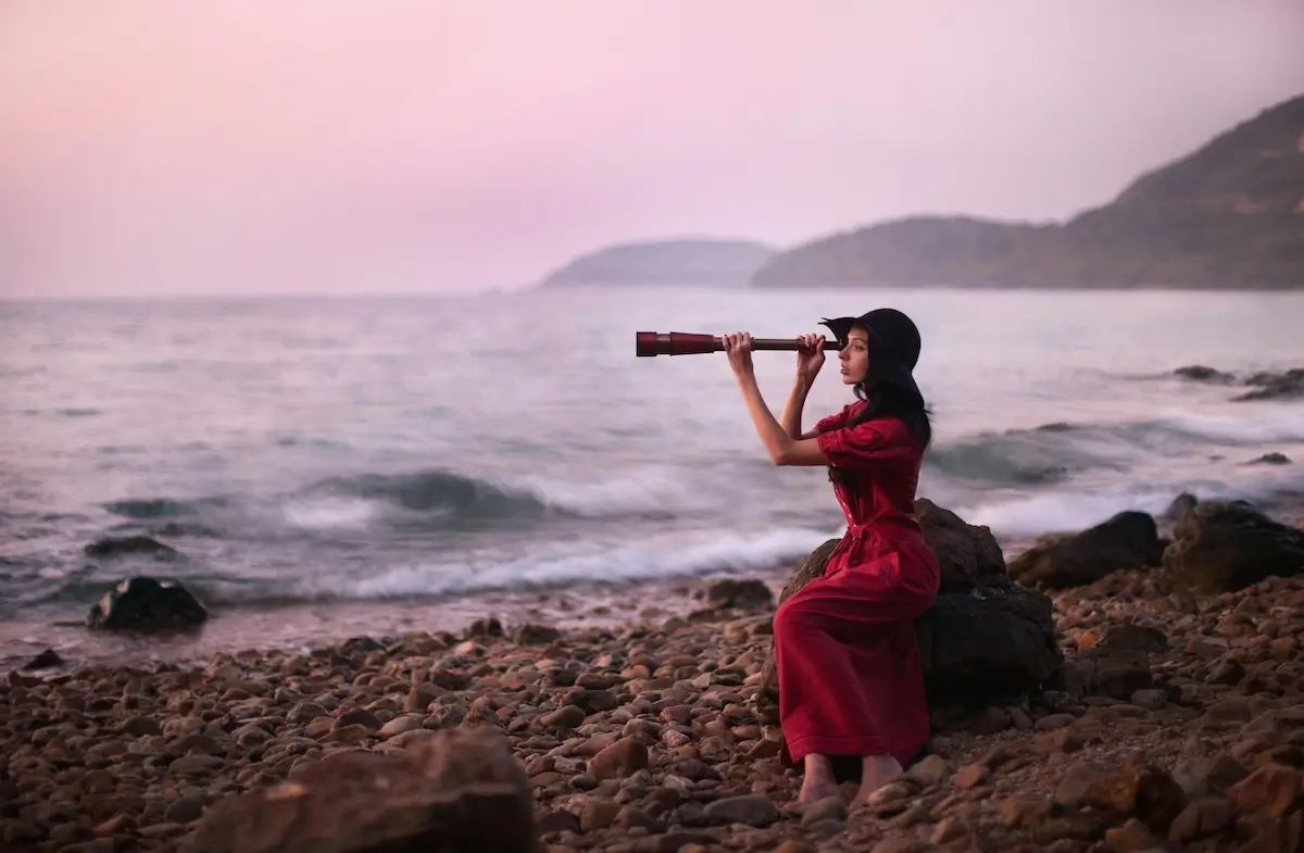 A woman in a red dress looking into a telescope searching for ChatGPT by Arthouse Studio on pexel.com