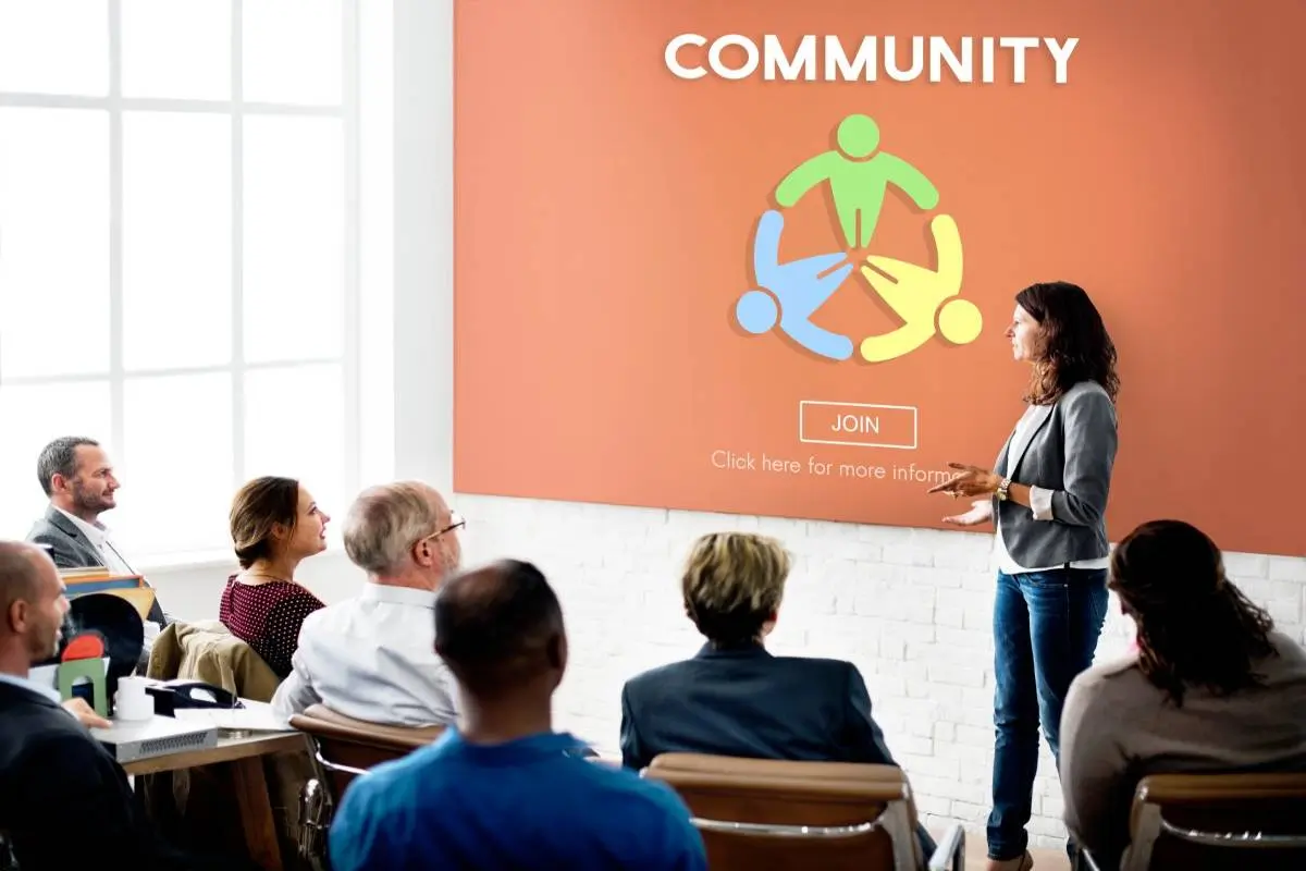 A woman presenting a meeting about Community