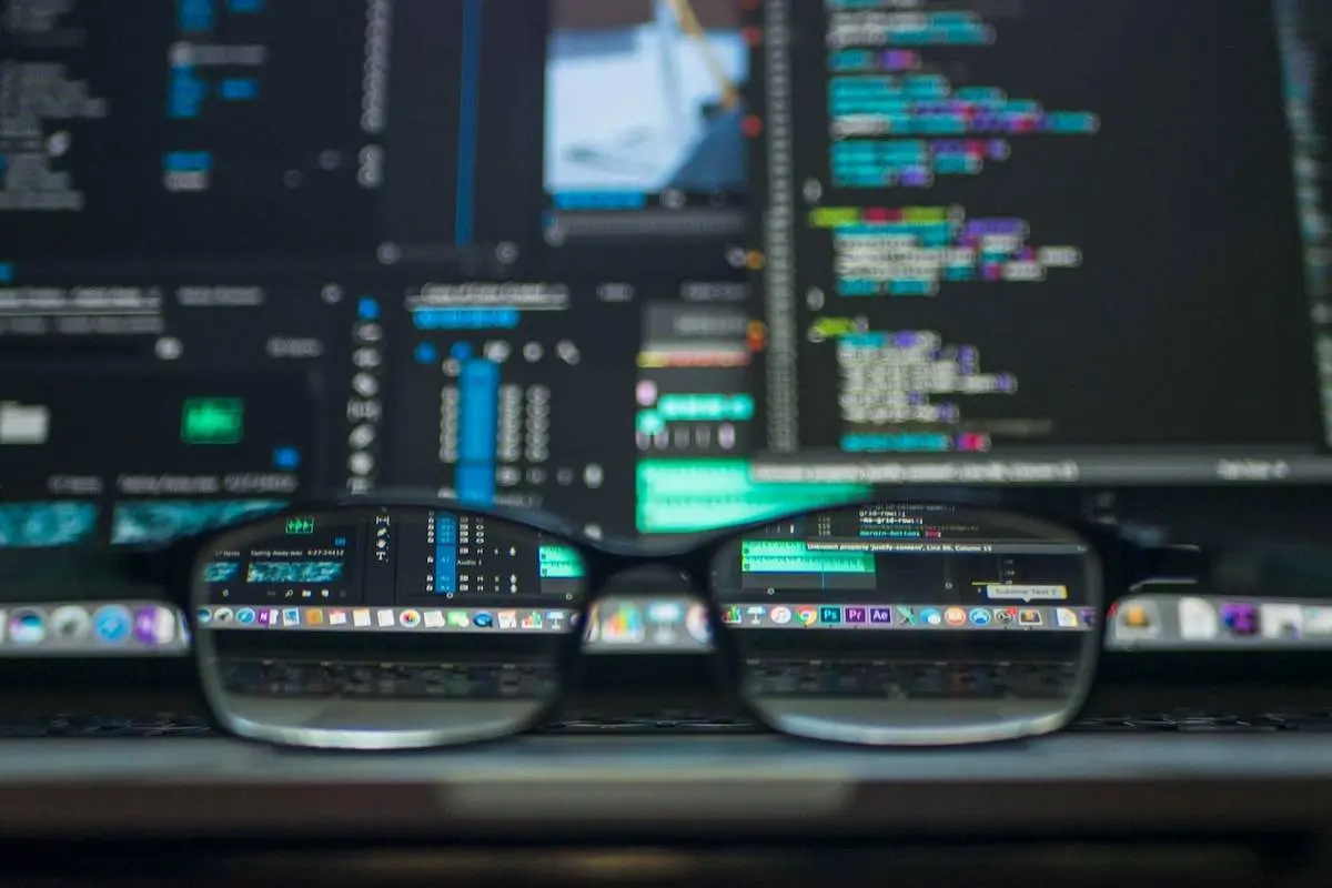 Glasses on a desk with screens in the background displaying Decentralised Identity data by Kevin Ku on Pexels.com