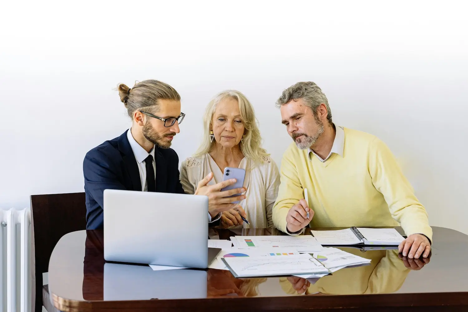 A business man shows a super agent to a couple at a table by Antoni Shkraba Studio on pexels. com