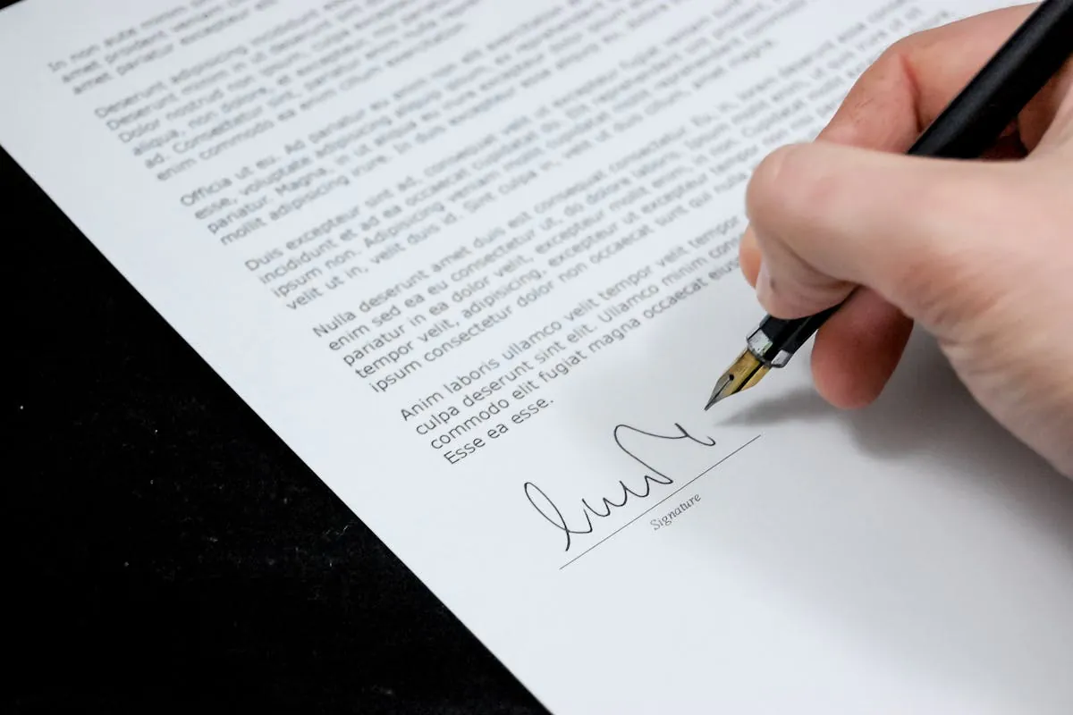 A man signing EU DeFi Compliance Checks by Pixabay on pexel.com