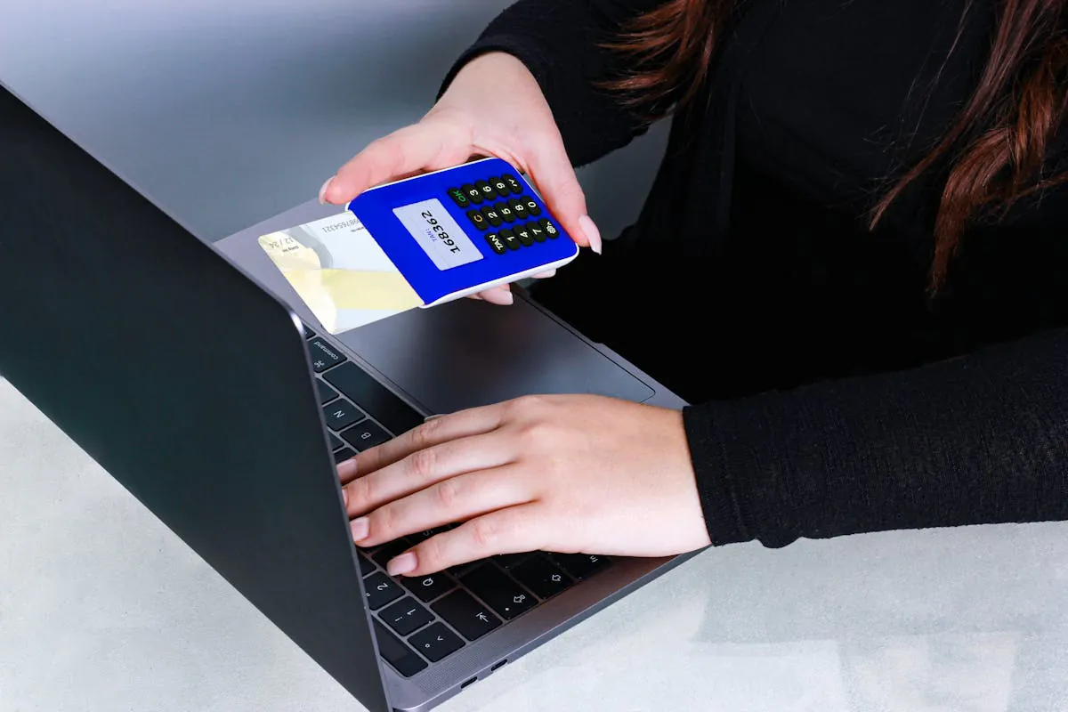 A Person in Black Long Sleeves Holding a POS Device with Card while Typing on a Laptop by REINER SCT on pexel.com (Stablecoin)
