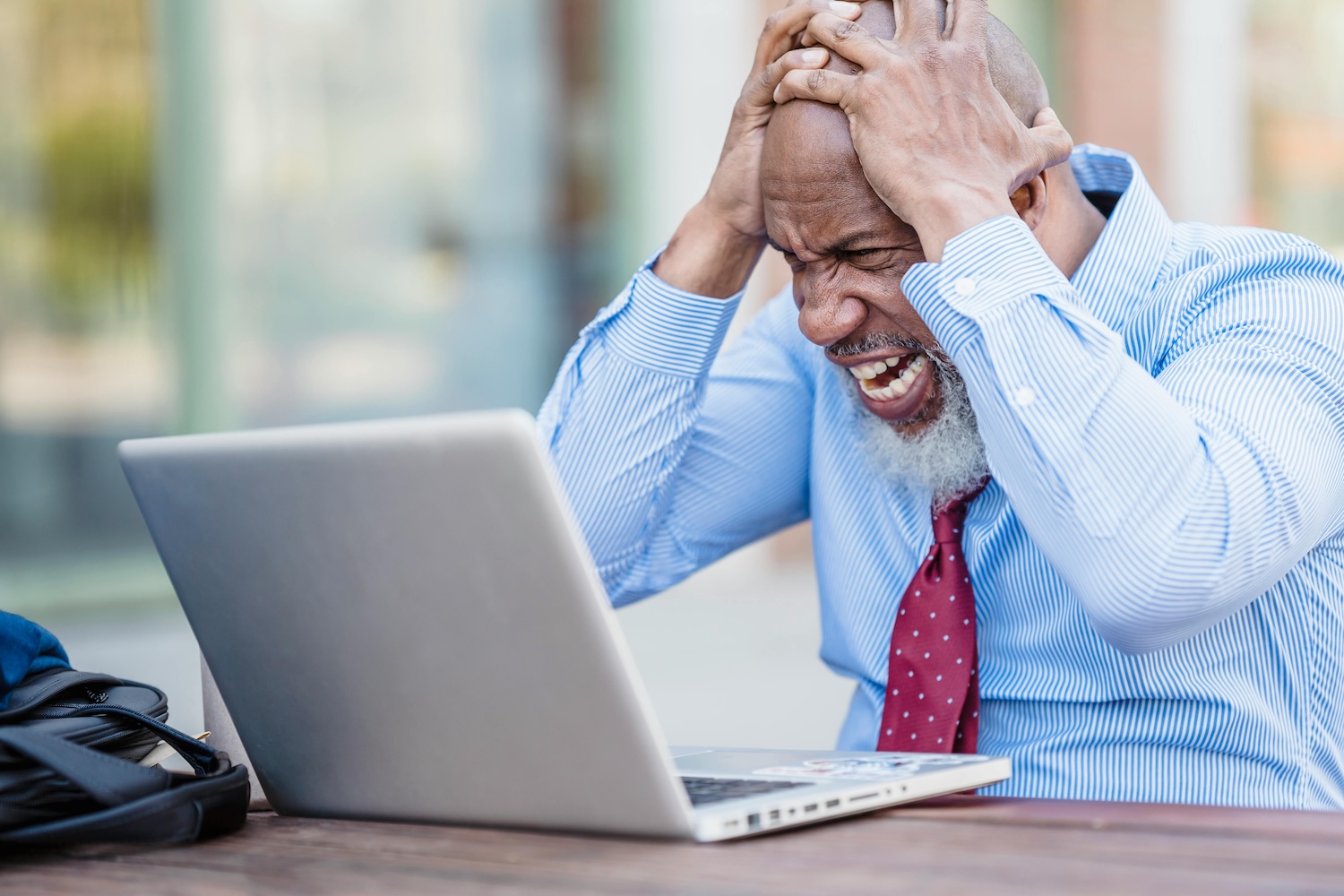 A man at his laptop frustrated by his businesses marketing growth by Nicola Barts on pexels