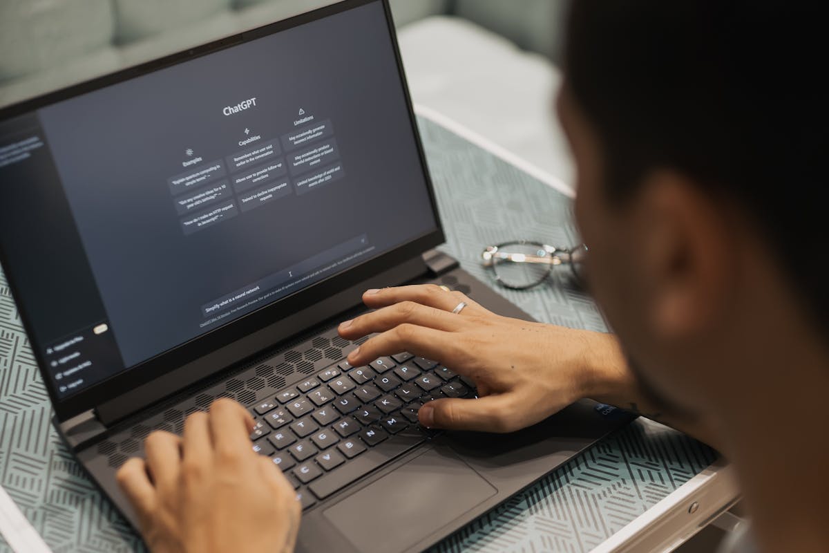 PR Man Using ChatGPT on a Laptop by Matheus Bertelli