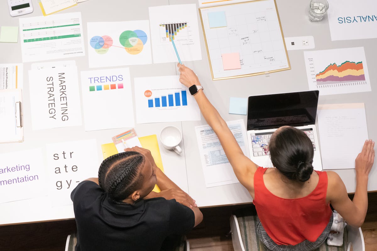 Woman in Red Top Pointing on the SEO Graph by Kindel Media