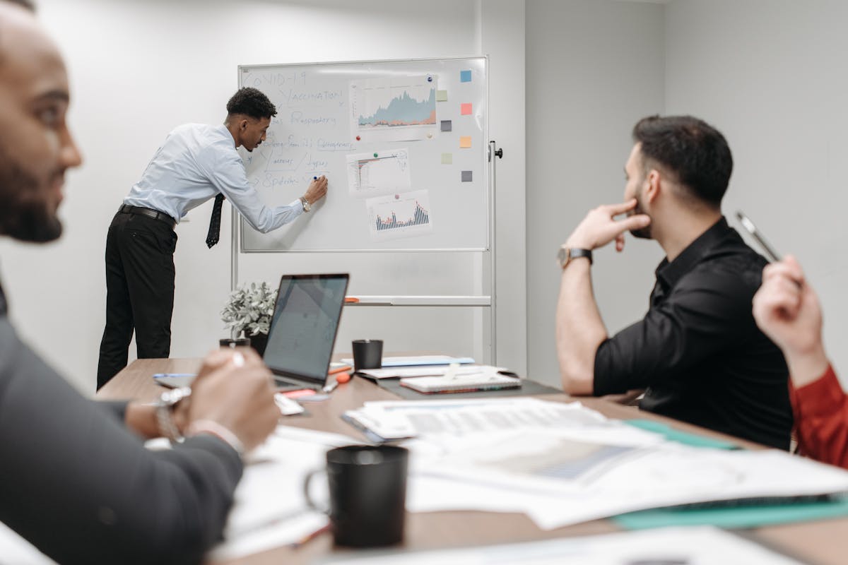 A man writing the DeFi protocol on a white board in an office Meeting by Pavel Danilyuk