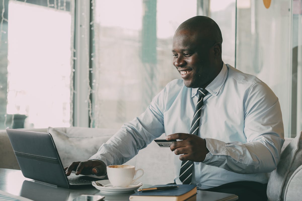 A Business man Online Shopping in Cafe by Vitaly Gariev