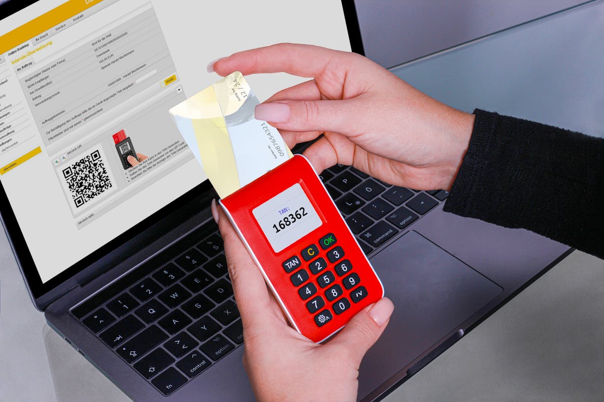 Woman using TAN generator for secure token on laptop, enhancing blockchain by REINER SCT