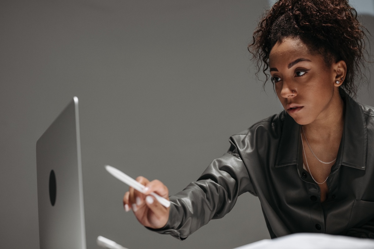A black woman pointing at a computer screen with her pen by Pavel Danilyuk on Pexels