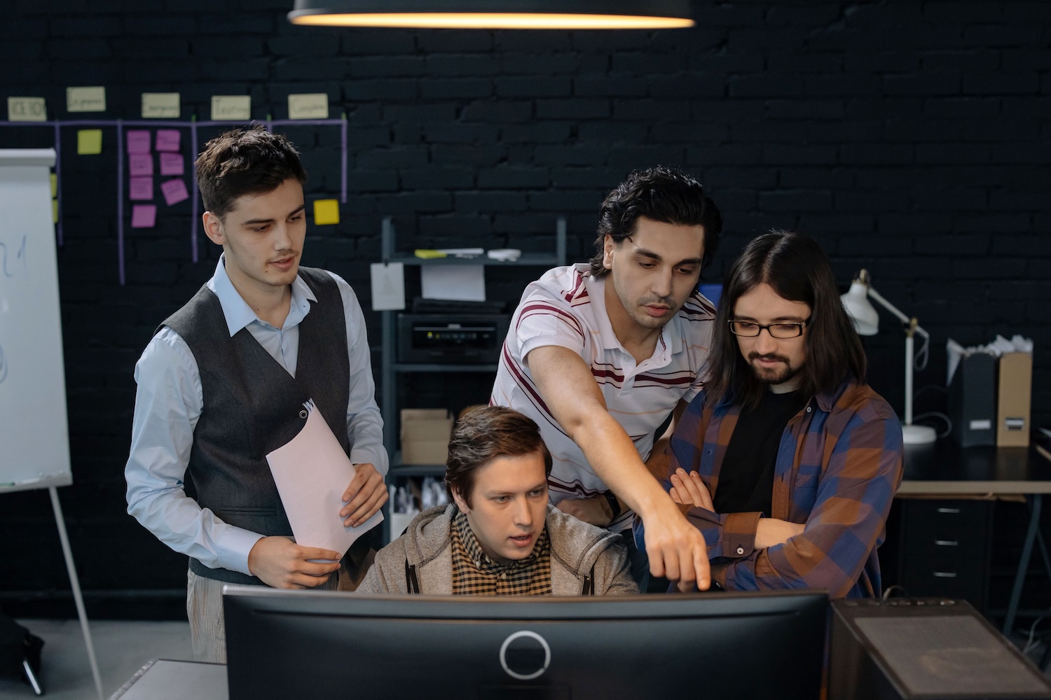 Web3 team, 4 young men at the computer with one pointing at the screen by cottonbro studio on Pexels