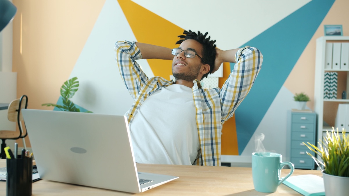 A satisfied young black man relaxed, leaning back in his office chair after managing to scale B2B sales by Vitaly Gariev on Pexels
