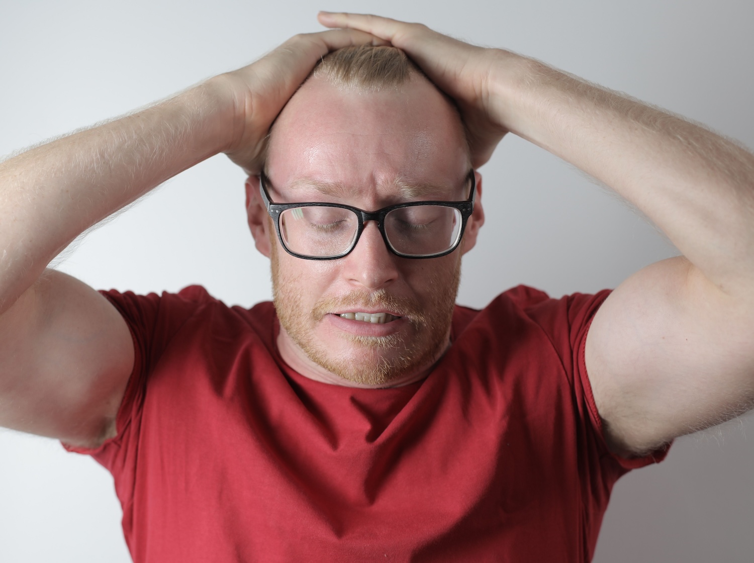 Distraught man with his hands pushing back his hair after his Google account hack by Andrea Piacquadio on Pexels